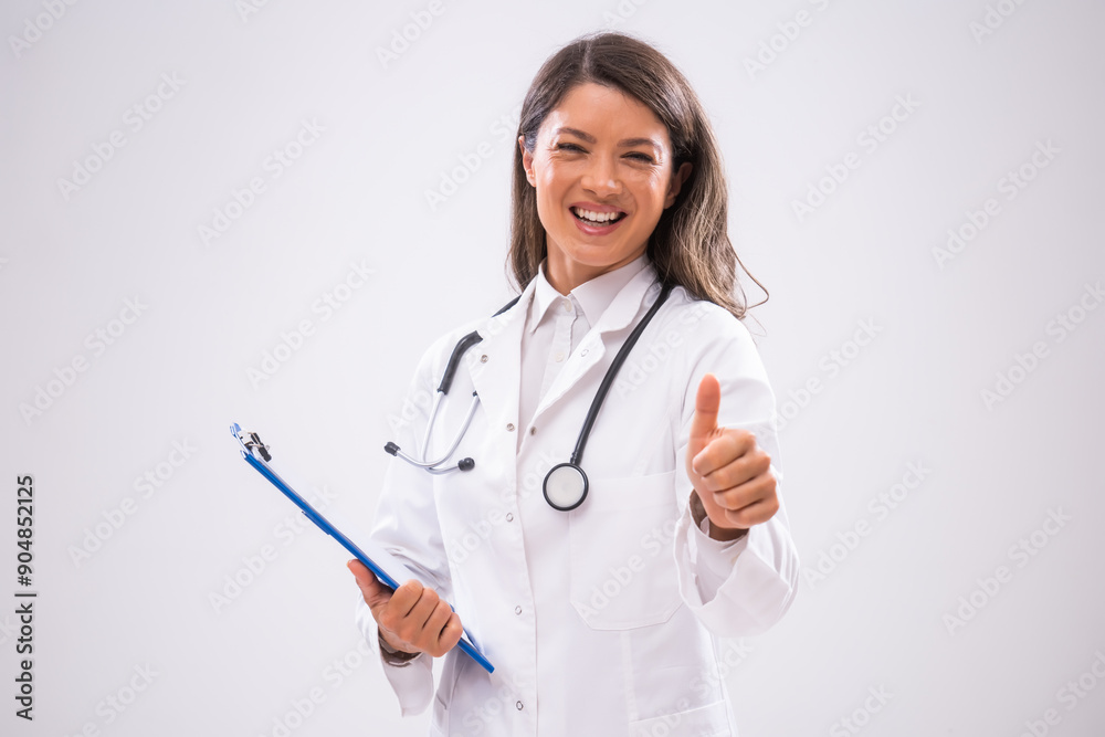 Portrait of doctor who is holding clipboard and showing thumbs up. Portrait of doctor who is holding clipboard and showing thumbs up.