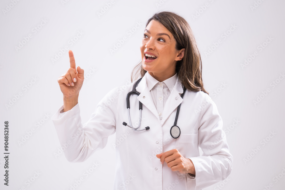 Portrait of doctor who is cheerful and pointing upside. Portrait of doctor who is cheerful and pointing upside.