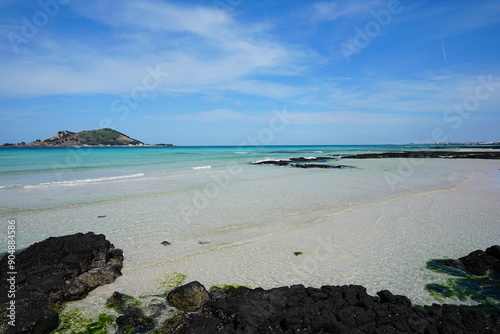 clear shoaling beach and far island