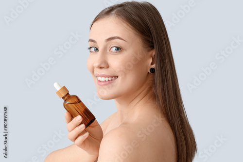 Beautiful woman with serum ...