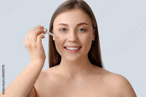 Beautiful woman applying se...