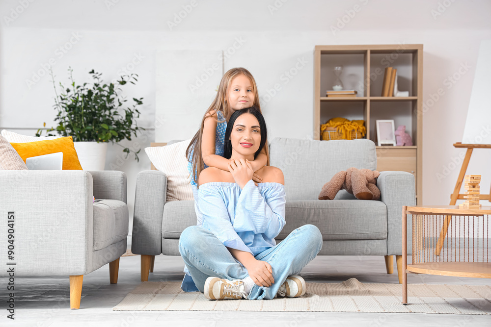 Happy mother with her little daughter hugging at home Happy mother with her little daughter hugging at home