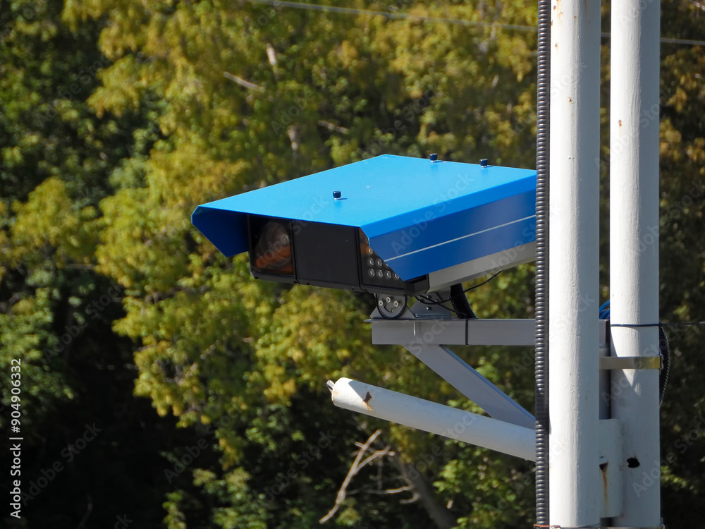 Close-up Of Security Camera On The Street. Control and monitoring system. Metal Pole. Green trees. july 2024. Ust-Kamenogorsk (kazakhstan) Close-up Of Security Camera On The Street. Control and monitoring system. Metal Pole. Green trees. july 2024. Ust-Kamenogorsk (kazakhstan)