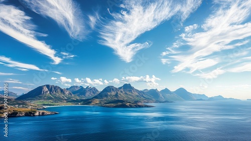 A high-angle view of the sea and mountains against a blue sky. photo