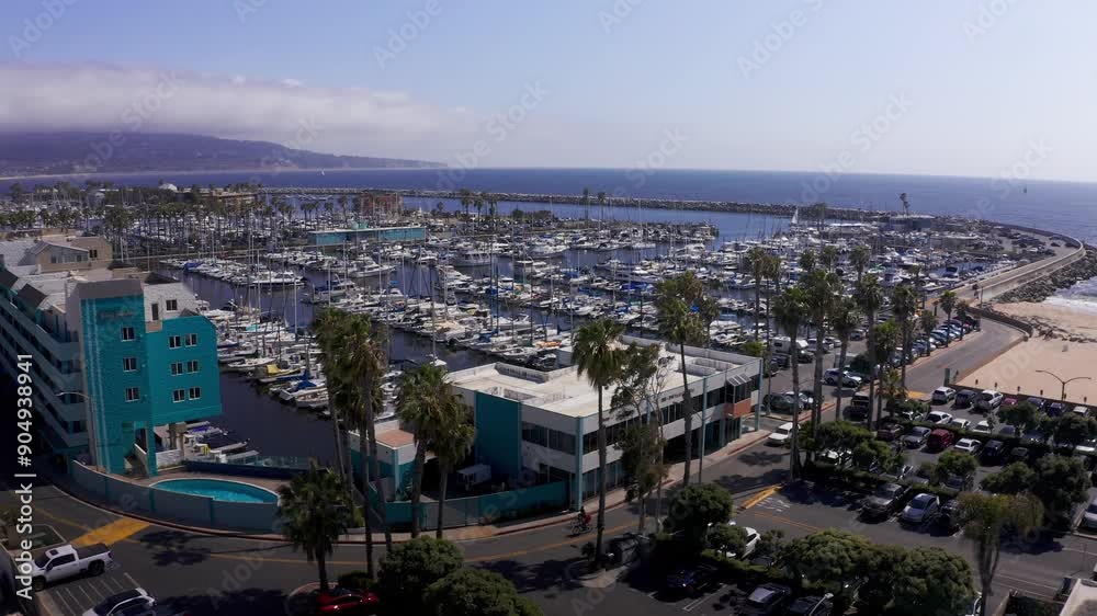 Low reverse pullback aerial shot of King Harbor Marina looking towards the Palos Verdes peninsula in Redondo Beach, California. 4K Low reverse pullback aerial shot of King Harbor Marina looking towards the Palos Verdes peninsula in Redondo Beach, California. 4K