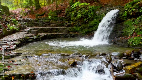 Several autumn waterfalls in a beech forest photo