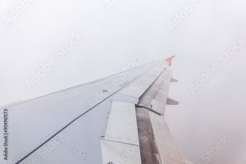 View from the airplane window at a beautiful cloudy sky and the airplane wing