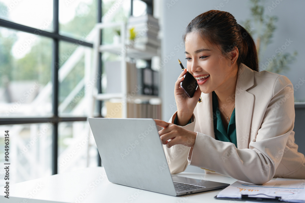 Asian businesswoman talking on the phone working in a modern office. Contacting customers. Customer manager, company sales. Contact online for finances startup business idea. Asian businesswoman talking on the phone working in a modern office. Contacting customers. Customer manager, company sales. Contact online for finances startup business idea.