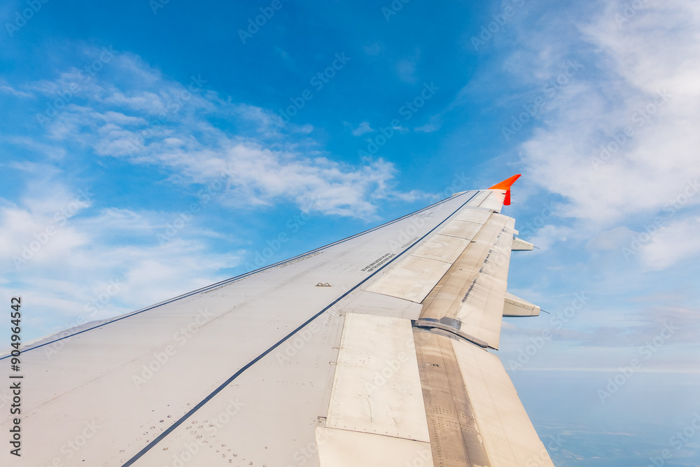 View from the airplane window at a beautiful cloudy sky and the airplane wing View from the airplane window at a beautiful cloudy sky and the airplane wing