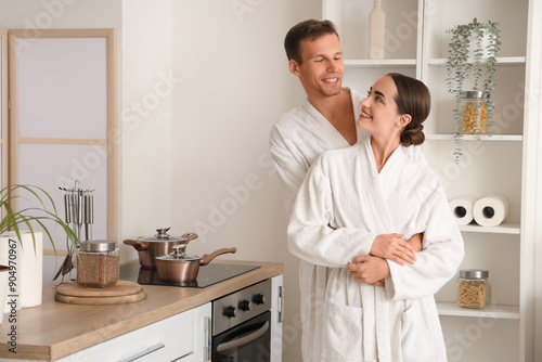 Young couple in bathrobes h...