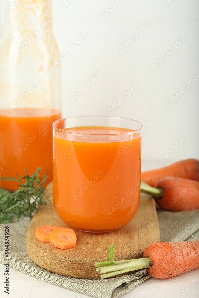 Fresh carrot juice and vegetables on light table Fresh carrot juice and vegetables on light table
