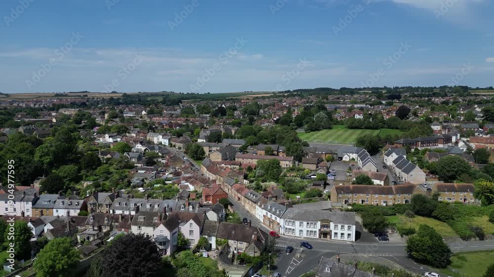 Sherborne, Dorset, England: DRONE VIEWS: Shows the south-east of the town of Sherborne including houses and roads. Sherborne is an affluent market town and popular UK tourist destination (Clip 1). Sherborne, Dorset, England: DRONE VIEWS: Shows the south-east of the town of Sherborne including houses and roads. Sherborne is an affluent market town and popular UK tourist destination (Clip 1).