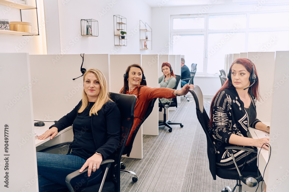 Team of Women Providing Customer Support in Call Center Environment. Team of Women Providing Customer Support in Call Center Environment.
