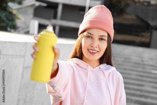 Young Asian woman with spra...