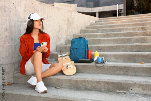 Young Asian woman in headph...