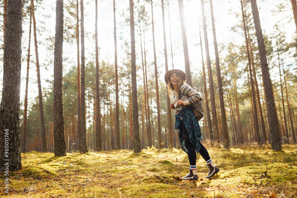 Young woman walks through natural forest. Tourist woman hiking alone in nature at sunset. Active lifestyle. People in forest. Nature, travel, rest concept. Young woman walks through natural forest. Tourist woman hiking alone in nature at sunset. Active lifestyle. People in forest. Nature, travel, rest concept.