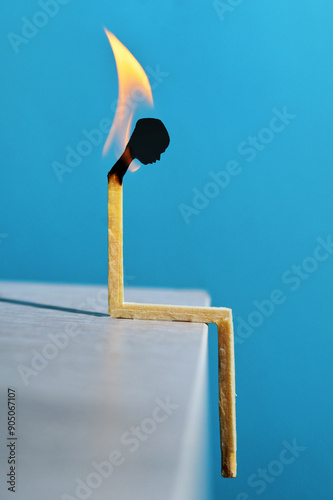 Person silhouette head match with flame light