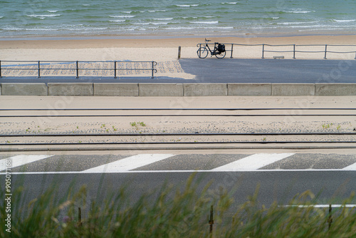 Artistic photo of Belgian coast featuring the sea, the promenade, tram tracks, and road. The vertical composition creates a graphic, almost abstract, representation of coastal elements, Middelkerke. photo