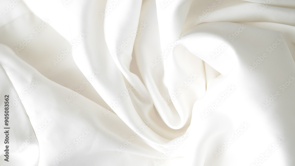 Obraz premium Crumpled white silk fabric background with soft folds and delicate texture.