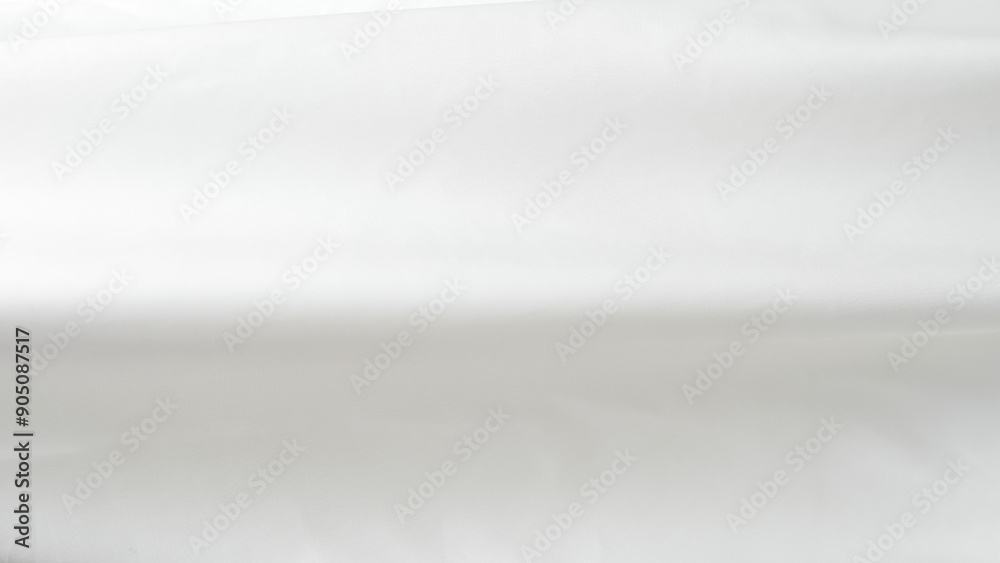 Crumpled white silk fabric background with soft folds and delicate texture. Crumpled white silk fabric background with soft folds and delicate texture.