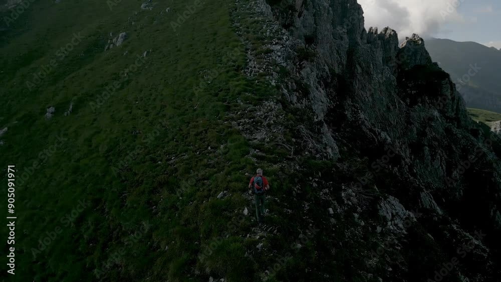 Man hiking in the Orobie Alps, Italy Man hiking in the Orobie Alps, Italy
