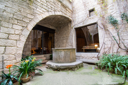 Stone courtyard with ancient well photo