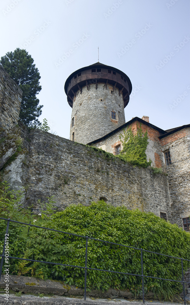 Castle defense tower with wooden ring. A defensive tower serving as a lookout point. Stone castle complex. Travel, sights, vacation, holidays Castle defense tower with wooden ring. A defensive tower serving as a lookout point. Stone castle complex. Travel, sights, vacation, holidays