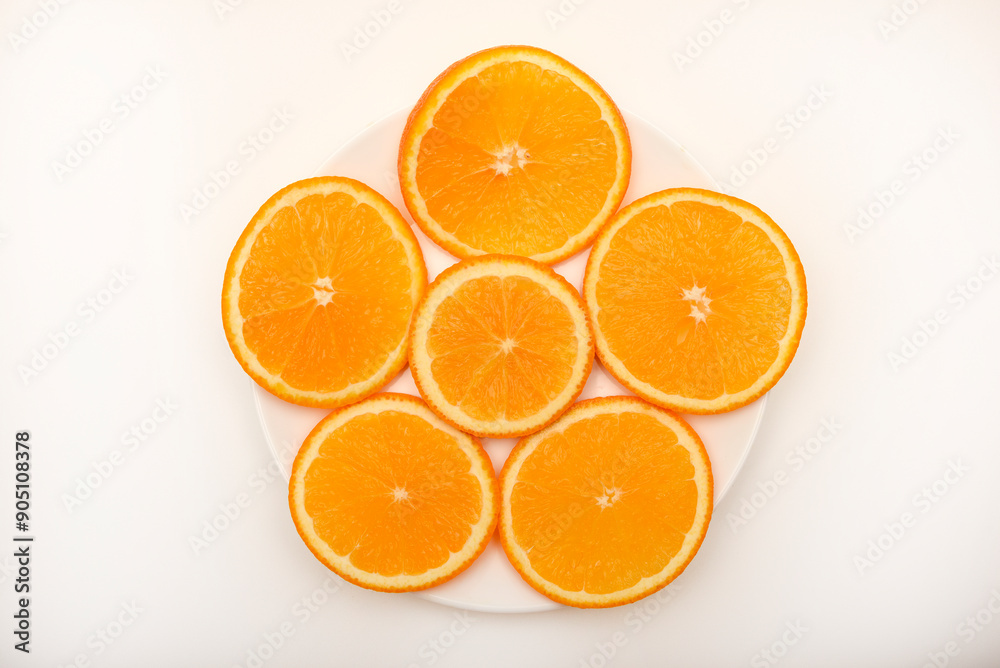 Flat slices of orange on a white plate. Chopped fruits. Flat slices of orange on a white plate. Chopped fruits.