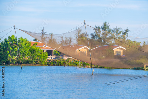 landscape of life and houses next to Thu Bon river in Hoi An ancient town, Quang Nam Province, Vietnam. Hoi An is one of the most popular destinations in Vietnam. photo