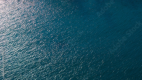 Serene ocean waters gently kissed by sunlight, evoking a sense of calm and tranquility