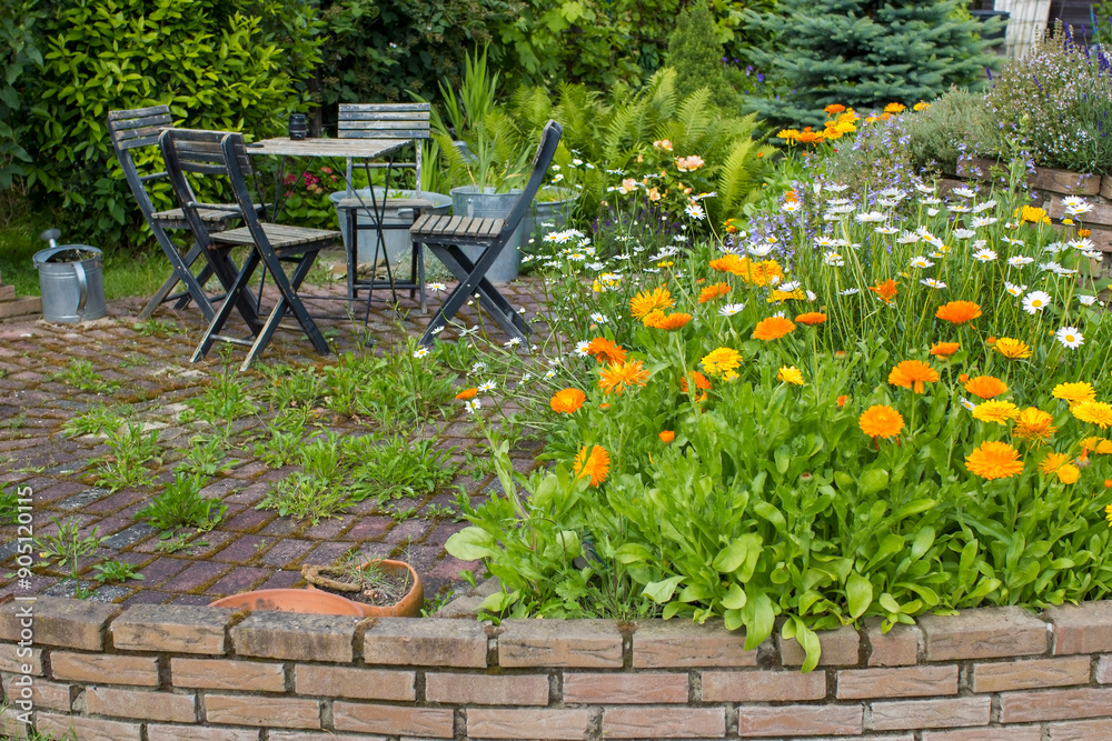 herb spiral in the garden with fresh herbs and flowers herb spiral in the garden with fresh herbs and flowers