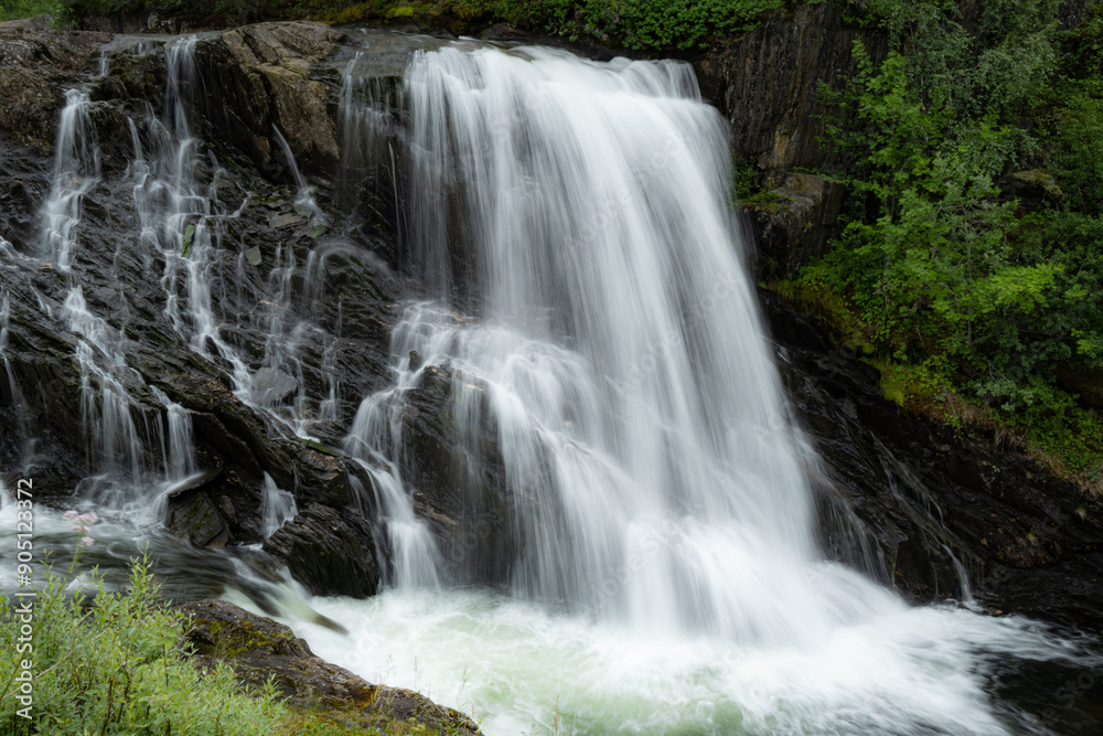 Small waterfall flowing over stones in the mountains of Rago, Northern Norway Small waterfall flowing over stones in the mountains of Rago, Northern Norway