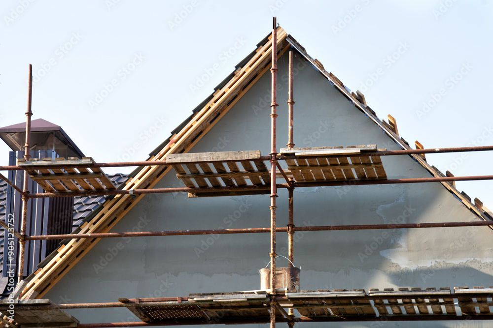 Fragment of the roof of a private residential building. Roof with sheathing for subsequent covering with iron tiles Fragment of the roof of a private residential building. Roof with sheathing for subsequent covering with iron tiles