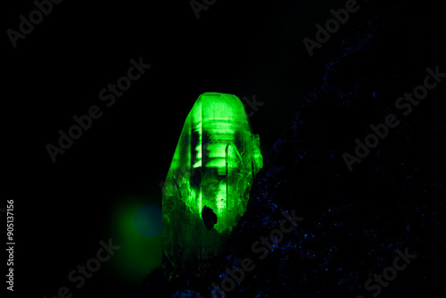 adamite under long wave UV. macro photography detail texture background. close-up raw rough unpolished semi-precious gemstone
 photo