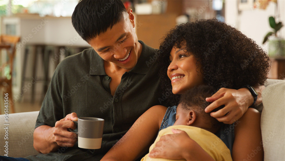 Family Bonding Moment at Home With Parents and Child in Cozy Living Room Smiling Family Bonding Moment at Home With Parents and Child in Cozy Living Room Smiling