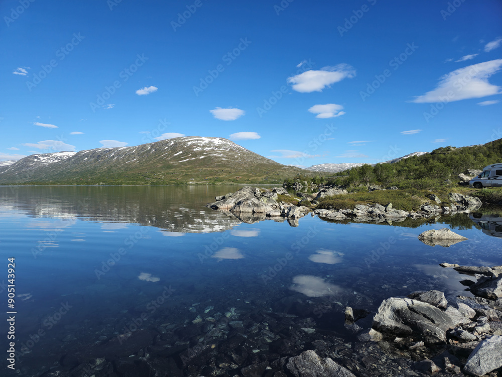 Naklejka premium Reflections of Snow-Capped Mountains on Serene Norwegian Lake in Summer