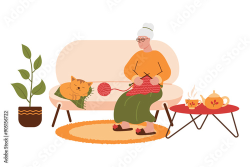 Elderly woman sitting and knitting on the sofa with knitting needles, ball of yarn and kitten