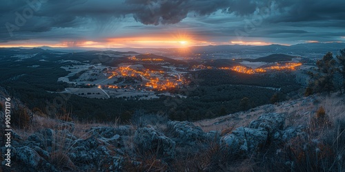 Panoramic view of a picturesque rural town nestled within a valley, illuminated by soft evening lights under a dramatic sunset and cloudy sky