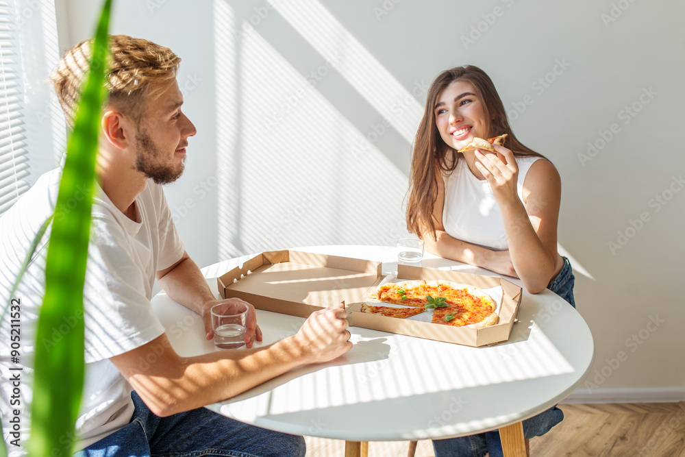 Couple Sharing Pizza in Sunlit Dining Area. Couple Sharing Pizza in Sunlit Dining Area.