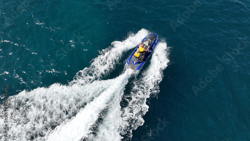 Wallpaper Mural Aerial drone top view photo of jet ski water craft approaching shore in mediterranean emerald crystal clear sea bay Torontodigital.ca