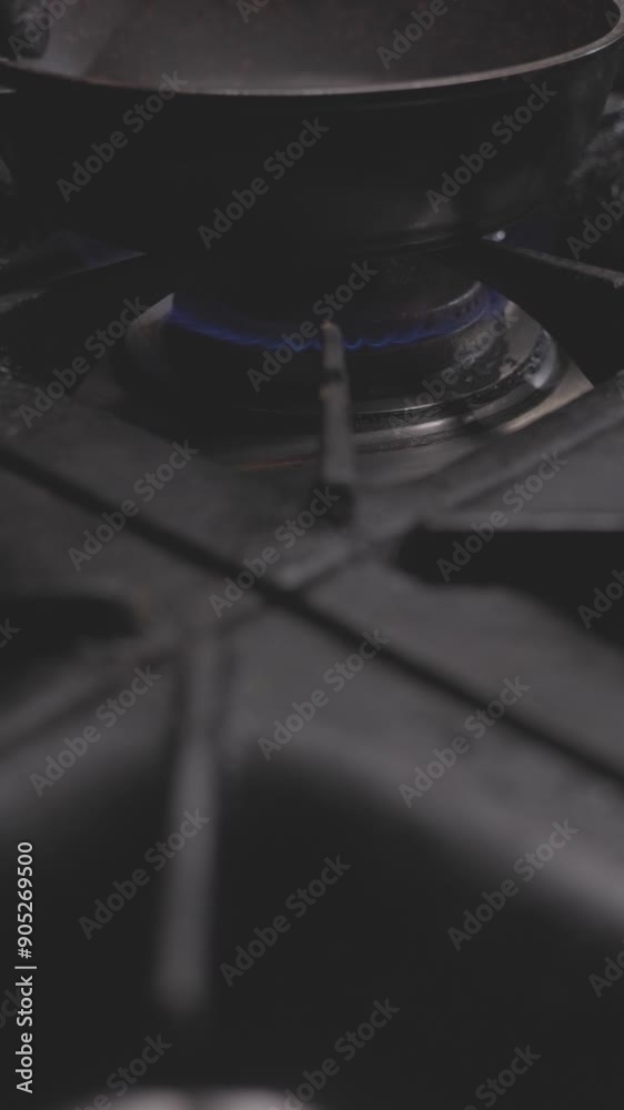 Cooking on a gas stove, heating pan on a burner Cooking on a gas stove, heating pan on a burner