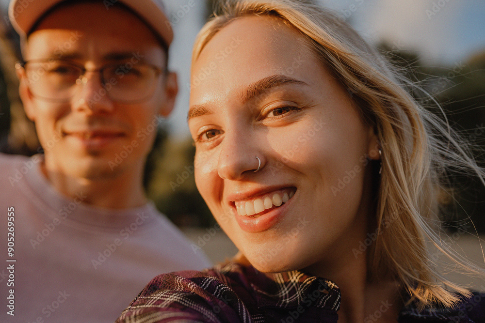 Obraz premium selfie of happy people guy and girl looking at camera and smiling. Selfie on date of young couple in love