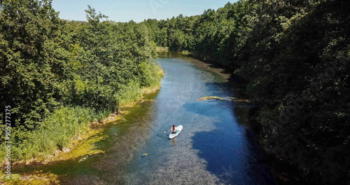 karst blue lake in the forest and SUP boards