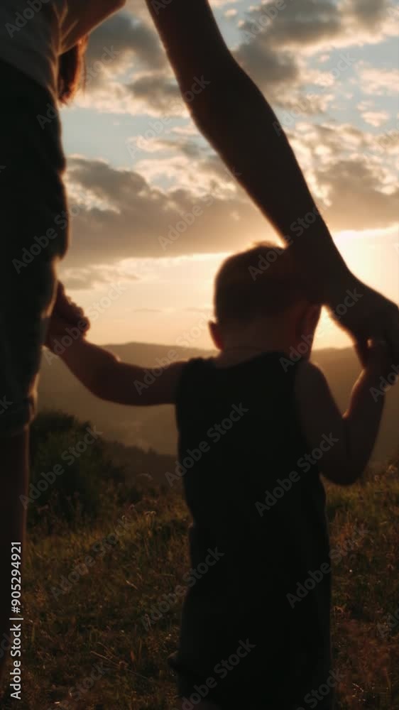 Vertical footage of caring mom helps her baby with first steps on ...