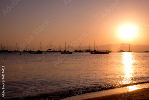 sunset with boats in silhouette in Santo Antonio de Lisboa, Florianópolis Brazil