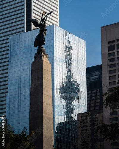 Canvas Print Reflection of the CN Tower in a glass building with a monument in the foreground