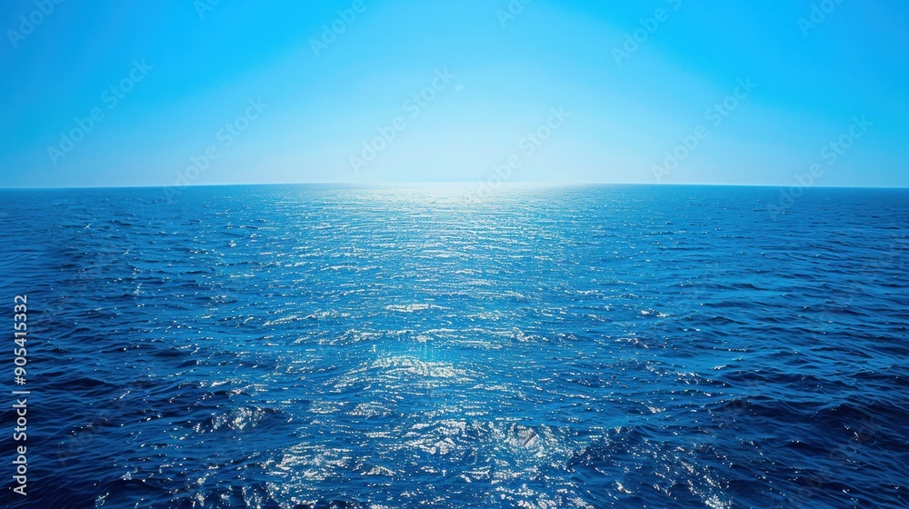Obraz premium A serene and expansive view of the blue sea stretching out to the horizon, where the azure waters meet the clear blue sky in a seamless union of color and light