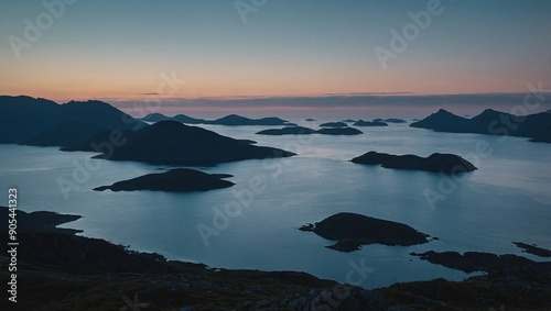 Twilight view of Nordic mountains, sea, and island silhouettes photo