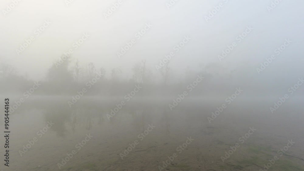 Time lapse foggy morning and mist motion over river in Chitwan national park. Jungles buffer zone on misty mysterious morning Time lapse foggy morning and mist motion over river in Chitwan national park. Jungles buffer zone on misty mysterious morning