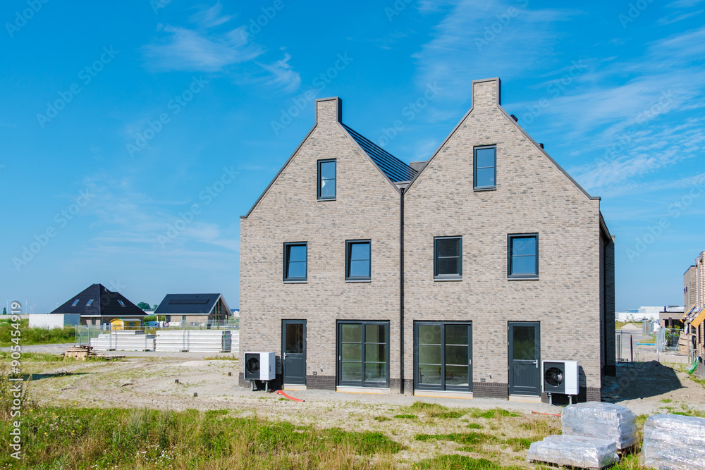 Modern Air Source Heat Pumps Installed at Newly Built Duplex Home in Sunny Environment Modern Air Source Heat Pumps Installed at Newly Built Duplex Home in Sunny Environment
